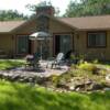 Raised terrace for fire pit directly off of patio, surrounded by perrenial bed filled with native plant materials.